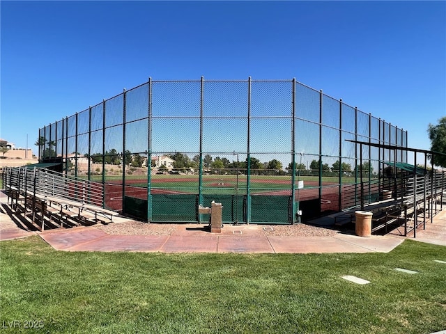 view of property's community featuring a yard, fence, and a tennis court