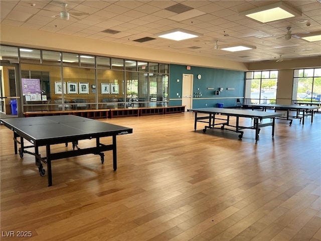 rec room featuring a drop ceiling and wood finished floors