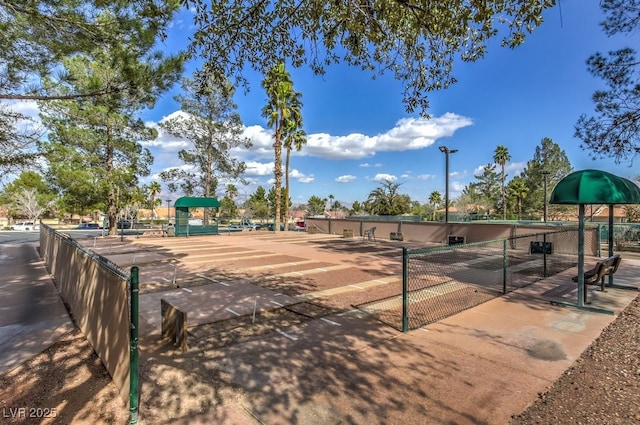 view of home's community featuring fence