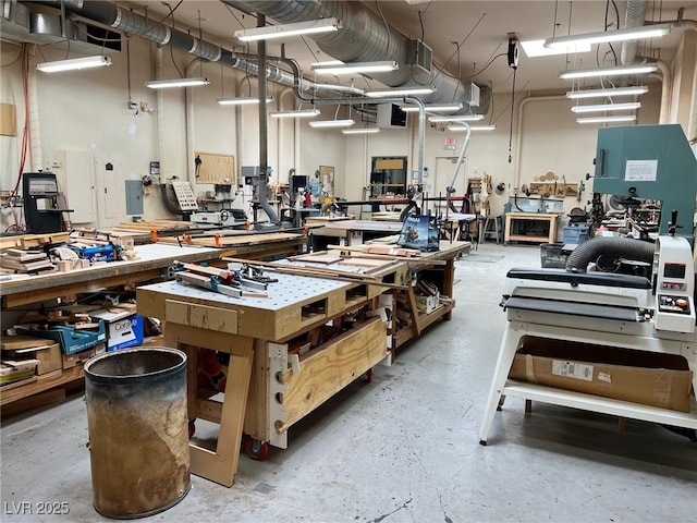 miscellaneous room featuring a workshop area and concrete floors