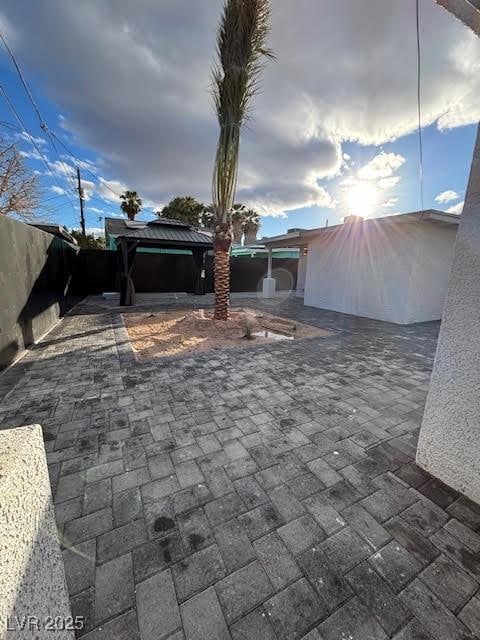 view of patio with a gazebo and fence
