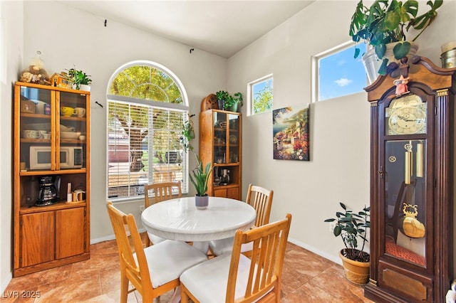 dining area with light tile patterned floors and baseboards