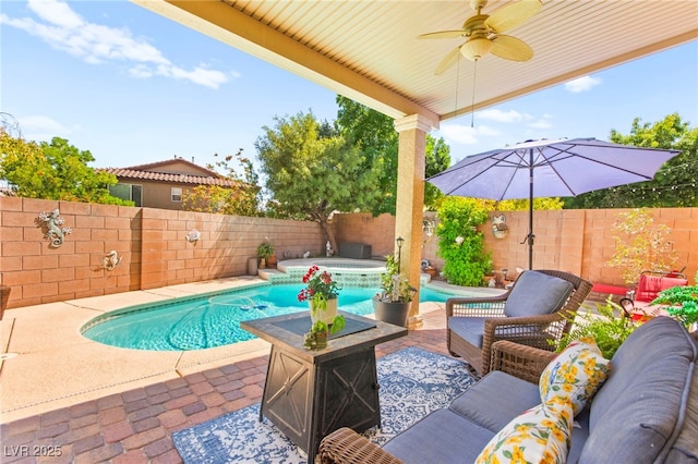 view of pool with a ceiling fan, an outdoor living space, a pool with connected hot tub, a patio area, and a fenced backyard