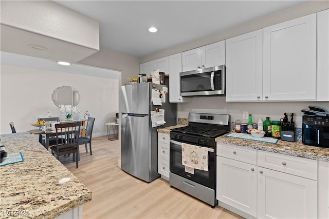 kitchen featuring stainless steel appliances and white cabinets