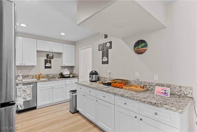 kitchen with light wood-style flooring, recessed lighting, visible vents, white cabinetry, and stainless steel appliances
