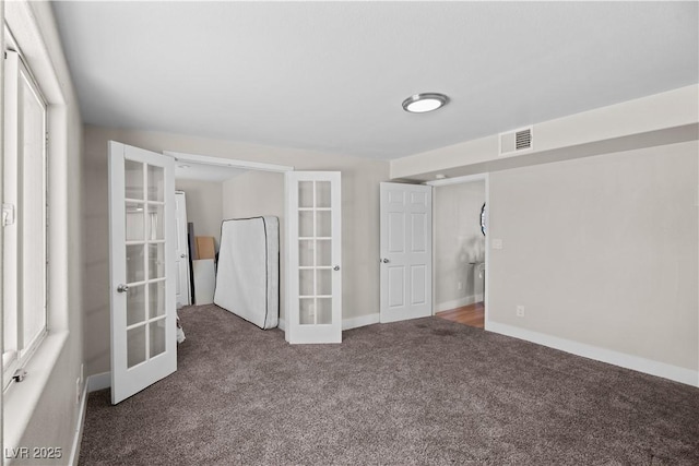 interior space featuring visible vents, french doors, baseboards, and carpet floors