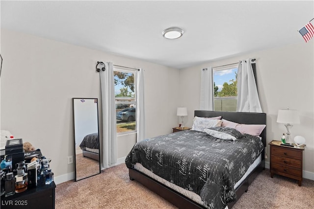 carpeted bedroom with baseboards and multiple windows