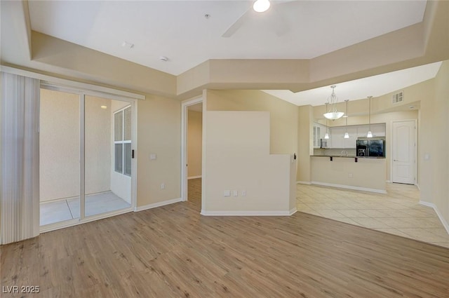 50 E Serene Ave Unit 420, Las Vegas, NV 89123 - unfurnished living room featuring light wood finished floors, ceiling fan, and baseboards