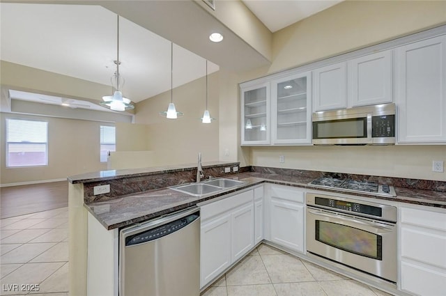 50 E Serene Ave Unit 420, Las Vegas, NV 89123 - kitchen with stainless steel appliances, a sink, light tile patterned flooring, a peninsula, and open floor plan