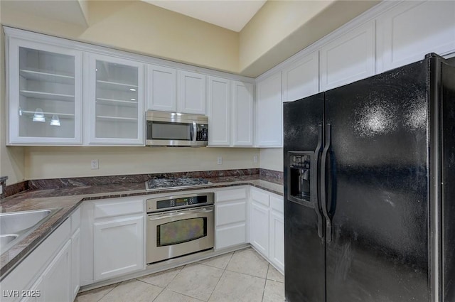 50 E Serene Ave Unit 420, Las Vegas, NV 89123 - kitchen with stainless steel appliances, white cabinets, light tile patterned flooring, glass insert cabinets, and a sink