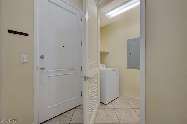 laundry room featuring light tile patterned floors, laundry area, electric panel, baseboards, and washer / dryer