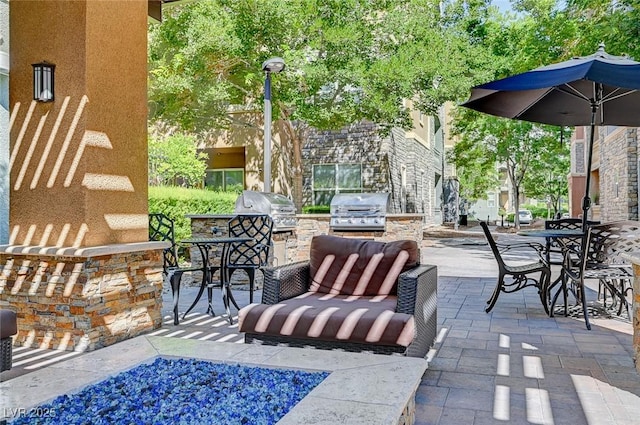 view of patio / terrace with area for grilling, an outdoor hangout area, and a grill