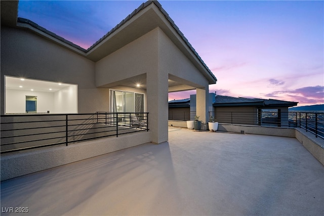 view of patio terrace at dusk
