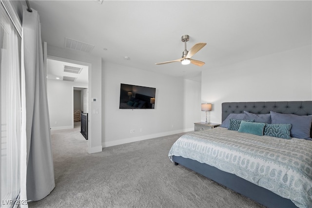bedroom featuring baseboards, carpet flooring, visible vents, and a ceiling fan