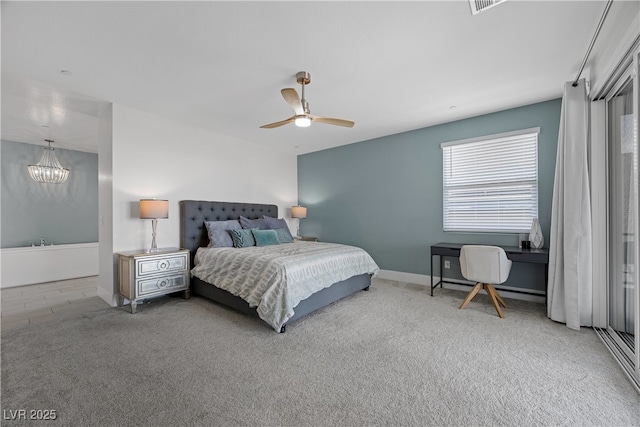 bedroom with carpet flooring, baseboards, and ceiling fan with notable chandelier