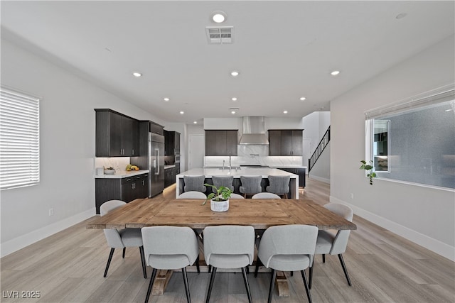 dining room with light wood-style floors, visible vents, baseboards, and recessed lighting