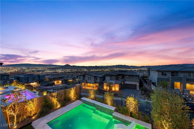 view of swimming pool featuring a mountain view, a residential view, a fenced in pool, and a fenced backyard