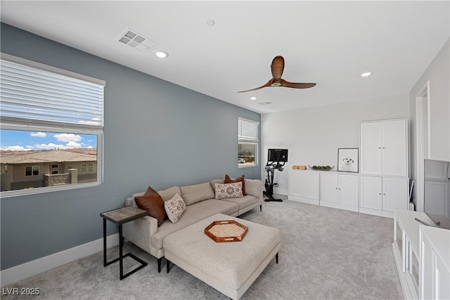 living room featuring recessed lighting, baseboards, ceiling fan, visible vents, and light colored carpet