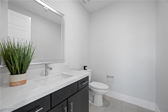 bathroom with tile patterned floors, toilet, baseboards, and vanity