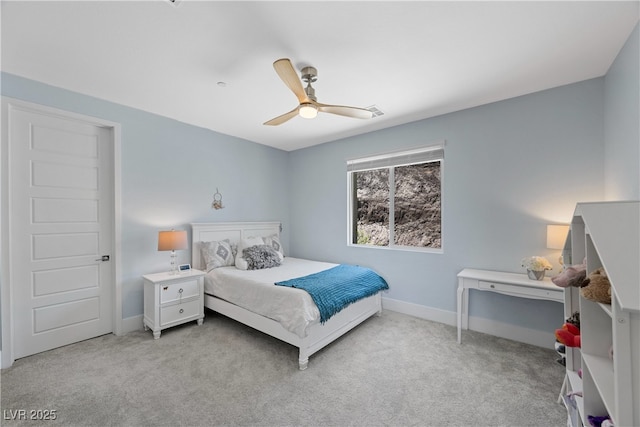bedroom featuring baseboards, ceiling fan, and light colored carpet