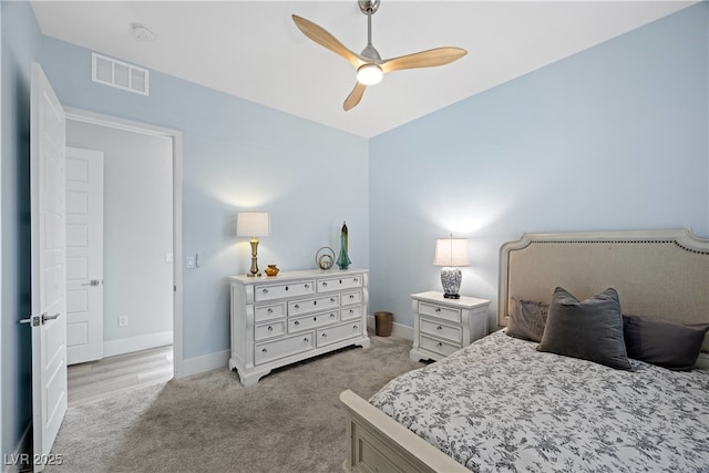 bedroom featuring baseboards, light carpet, visible vents, and a ceiling fan
