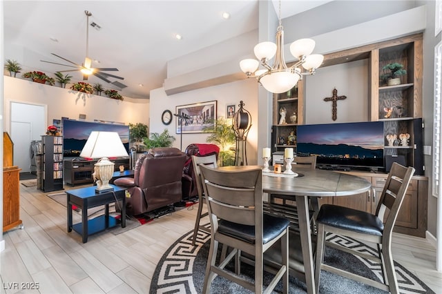dining area featuring lofted ceiling, a chandelier, and visible vents