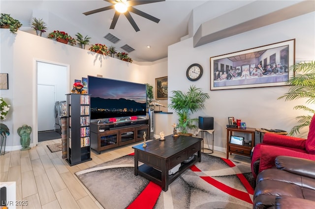 living area with lofted ceiling, baseboards, visible vents, and ceiling fan