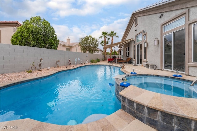 view of swimming pool with a pool with connected hot tub, a patio, and a fenced backyard