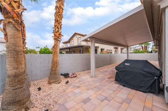 view of patio / terrace with grilling area and a fenced backyard