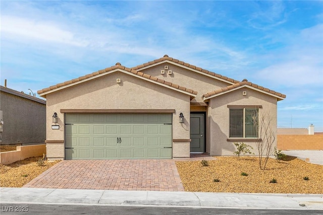 6725 Lotus Vista Ct, Las Vegas, NV 89156 - view of front facade with a garage, stucco siding, and decorative driveway