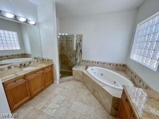 full bathroom with a stall shower, a jetted tub, and vanity