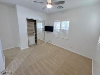 unfurnished bedroom with a ceiling fan, a closet, visible vents, baseboards, and light colored carpet