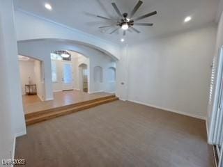 empty room with ceiling fan, arched walkways, and recessed lighting