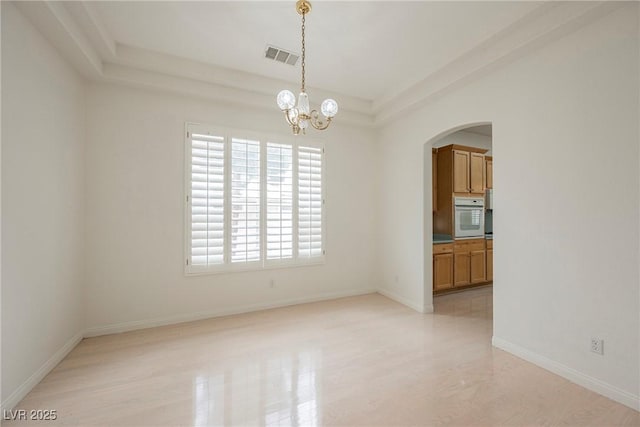 1100 Cypress Ridge Ln, Las Vegas, NV 89144 - spare room featuring arched walkways, a chandelier, and baseboards