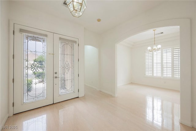 1100 Cypress Ridge Ln, Las Vegas, NV 89144 - foyer featuring a chandelier, arched walkways, wood finished floors, french doors, and baseboards