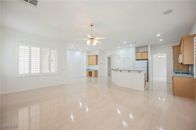 1100 Cypress Ridge Ln, Las Vegas, NV 89144 - unfurnished living room with arched walkways, a ceiling fan, recessed lighting, a chandelier, and light wood finished floors
