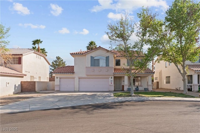 1287 Dove Tree Ct, Henderson, NV 89014 - mediterranean / spanish home featuring fence, driveway, a garage, stucco siding, and a tiled roof