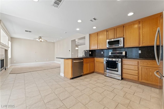 1287 Dove Tree Ct, Henderson, NV 89014 - kitchen with dark countertops, appliances with stainless steel finishes, visible vents, and a sink