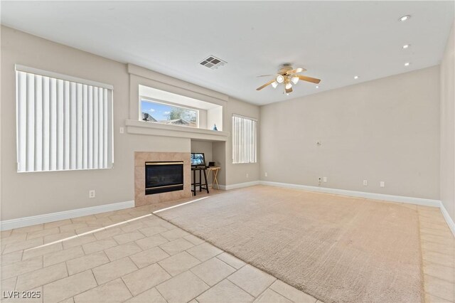 1287 Dove Tree Ct, Henderson, NV 89014 - unfurnished living room featuring a tile fireplace, visible vents, baseboards, and ceiling fan