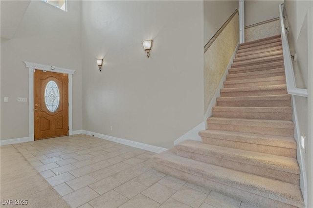 1287 Dove Tree Ct, Henderson, NV 89014 - foyer with stairway, a healthy amount of sunlight, light tile patterned flooring, and a towering ceiling
