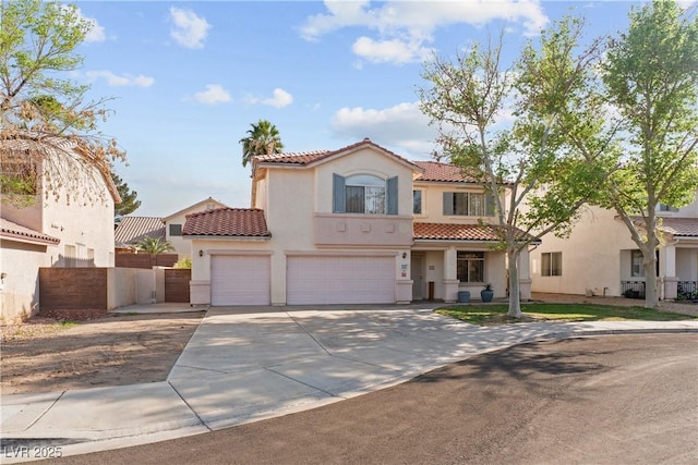 1287 Dove Tree Ct, Henderson, NV 89014 - mediterranean / spanish-style home with fence, a garage, stucco siding, a tile roof, and concrete driveway