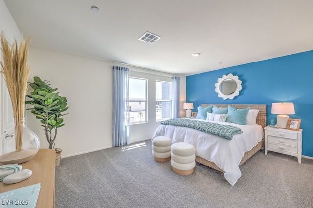 carpeted bedroom with visible vents and baseboards