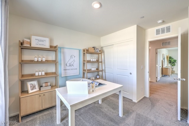 home office featuring light carpet, baseboards, and visible vents