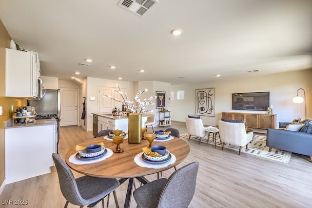 dining room with light wood-style flooring, visible vents, and recessed lighting