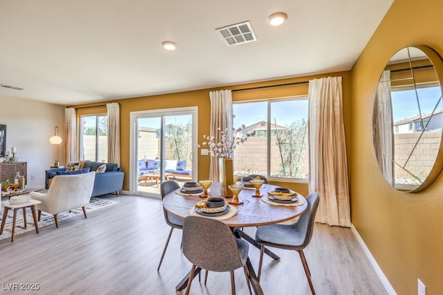 dining room with visible vents, light wood-style flooring, baseboards, and recessed lighting