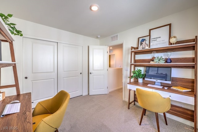 carpeted office space featuring baseboards and visible vents