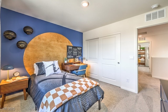 carpeted bedroom with a closet, visible vents, and baseboards