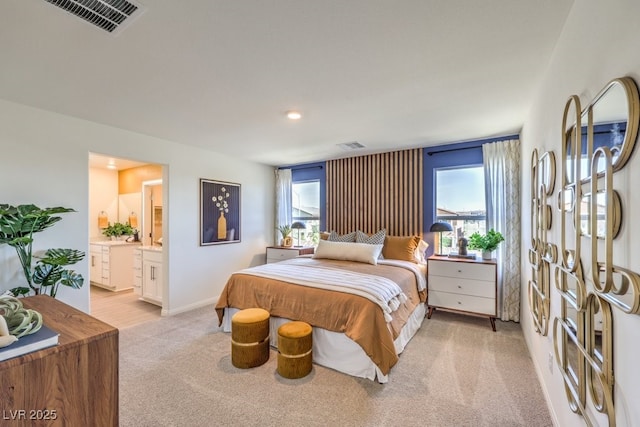 bedroom featuring light colored carpet, connected bathroom, and visible vents