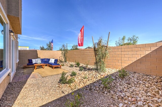 view of yard featuring an outdoor hangout area, a patio area, and a fenced backyard