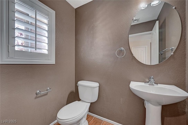 1158 Gecko Rd, Henderson, NV 89002 - half bathroom featuring toilet, wood finished floors, and baseboards